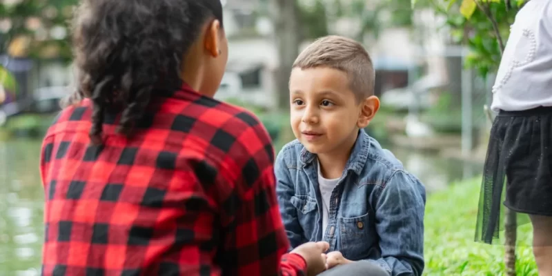 children-facing-each-other-talking-in-a-natural-pa-2025-08-27-02-46-10-utc
